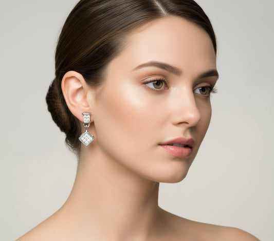 Pair of diamond stud earrings on a light gray background