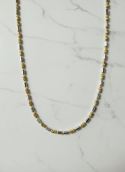 Beaded necklace on a marble surface