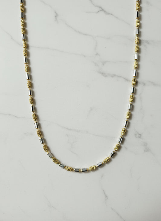 Beaded necklace on a marble surface