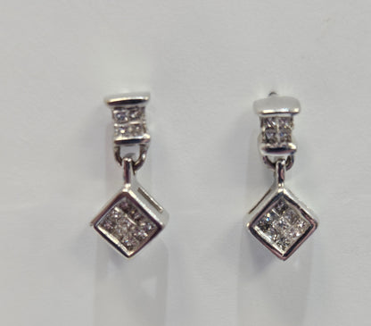 Pair of diamond stud earrings on a light gray background
